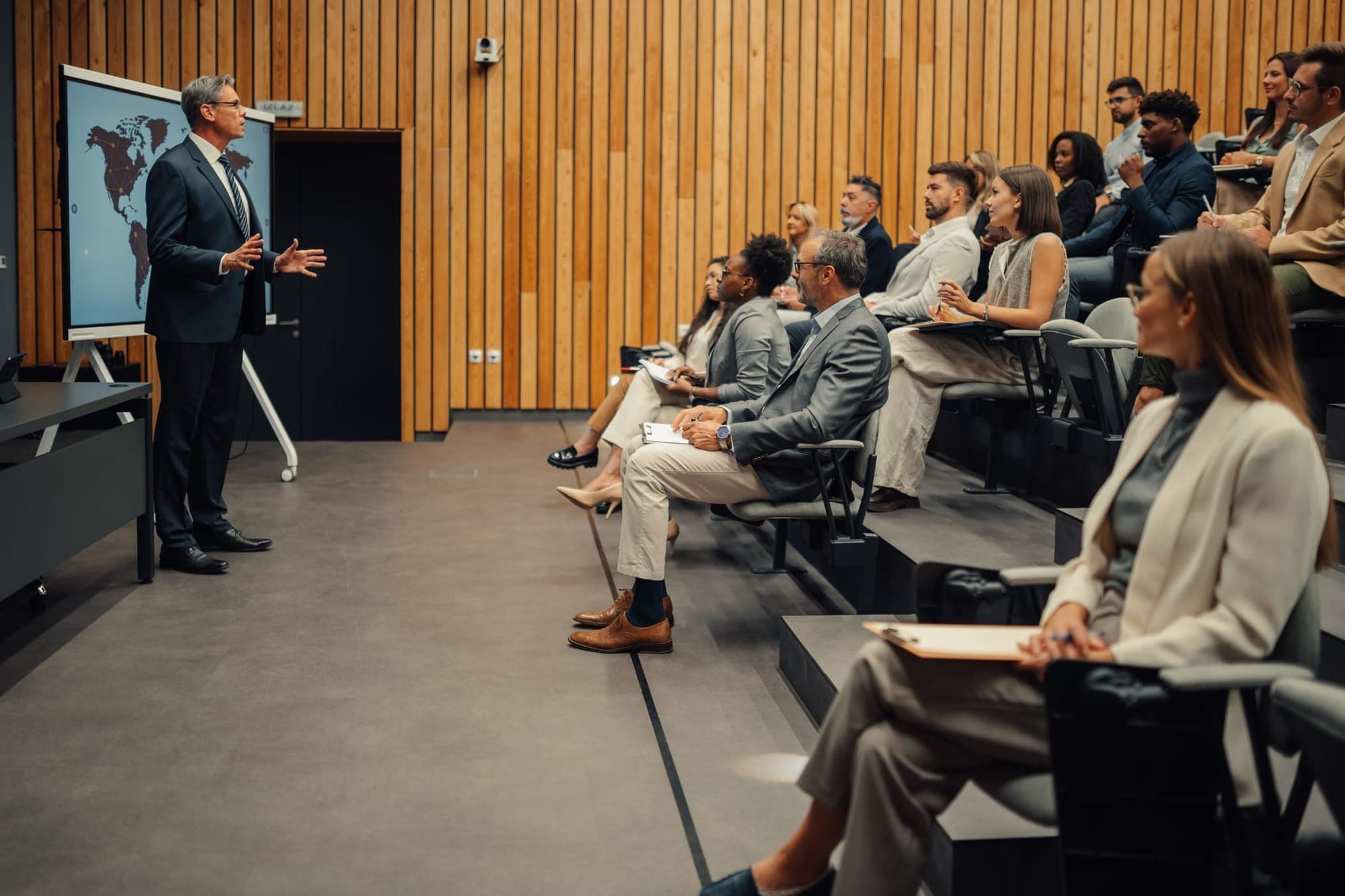 A presenter leading a session in a lecture room