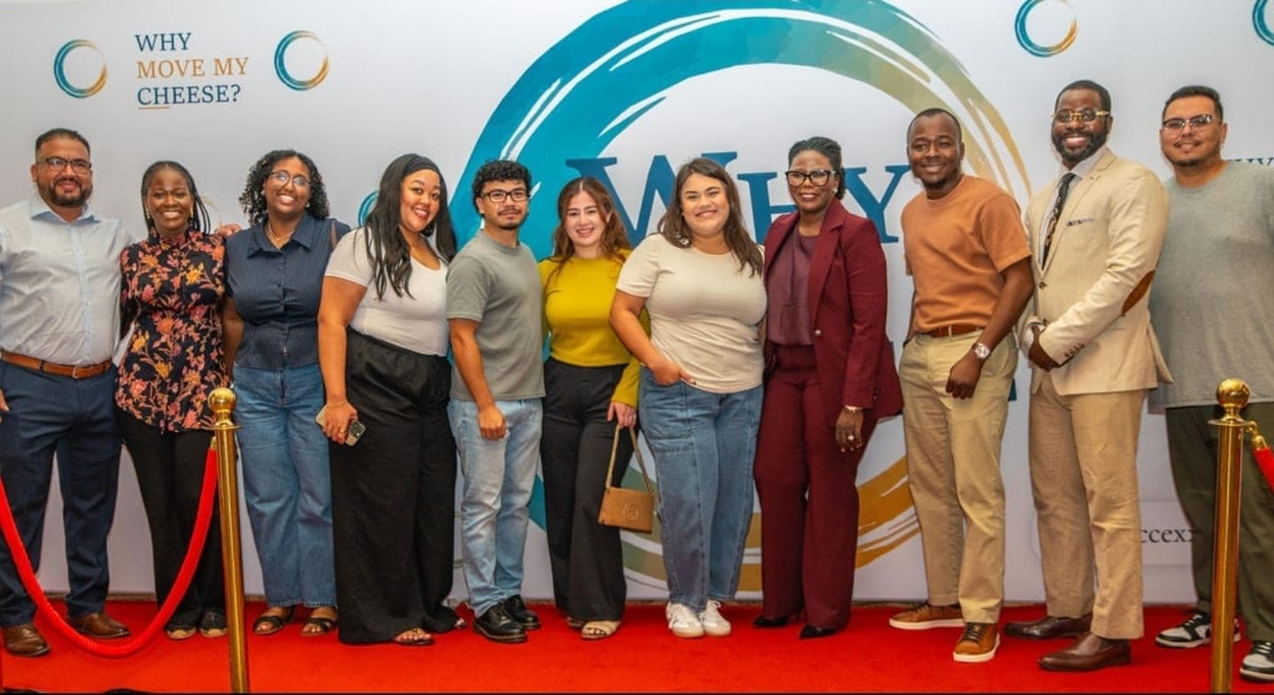 Attendees together at the Why Move My Cheese? backdrop