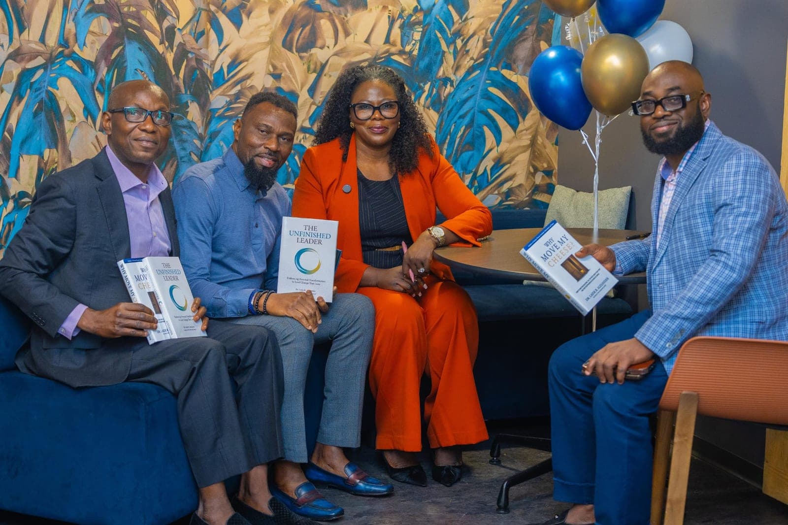 Guests on the book launch panel holding Dr. A's books