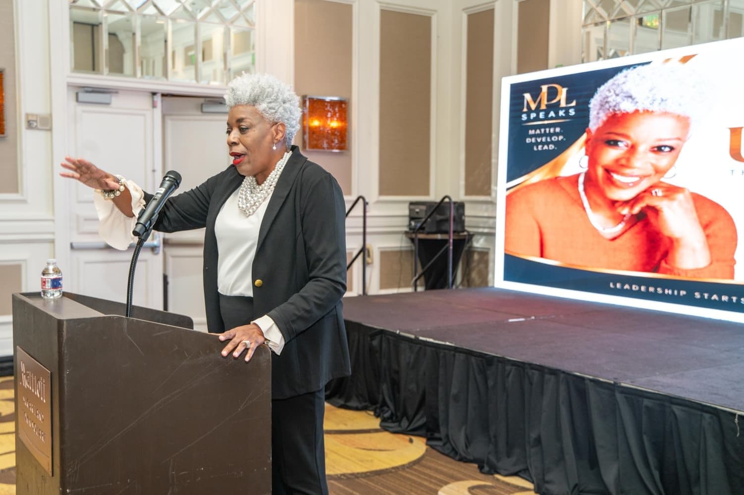 A speaker at the lectern during the conference