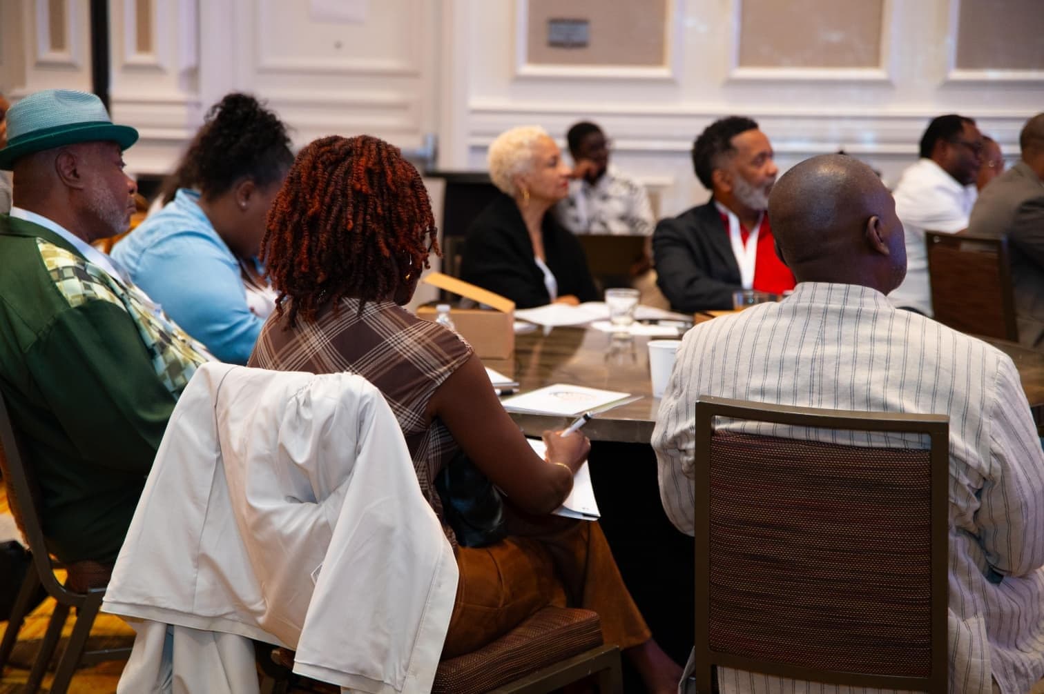 Attendees seated at conference tables